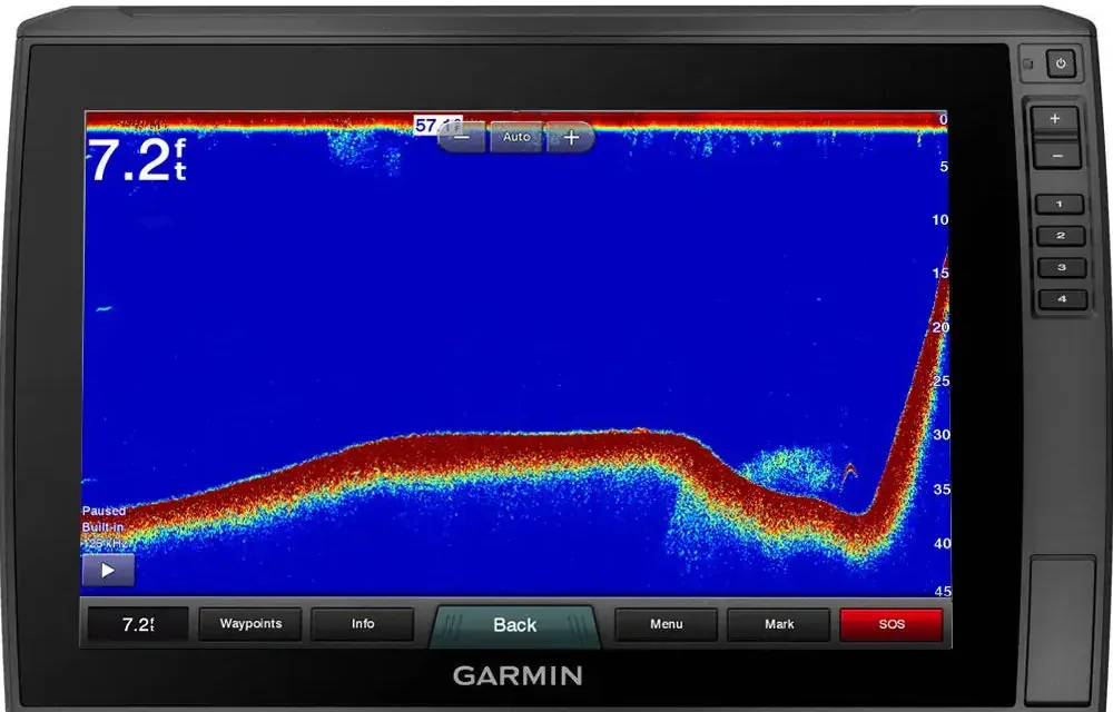 Garmin 2D sonar screen with a red bottom line that runs flat and then climbs steeply on the right, with a small cloud of bait and one fish arch near the bottom of the slope